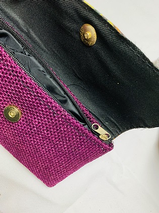 inside purple clutch with hand sewn embroidery